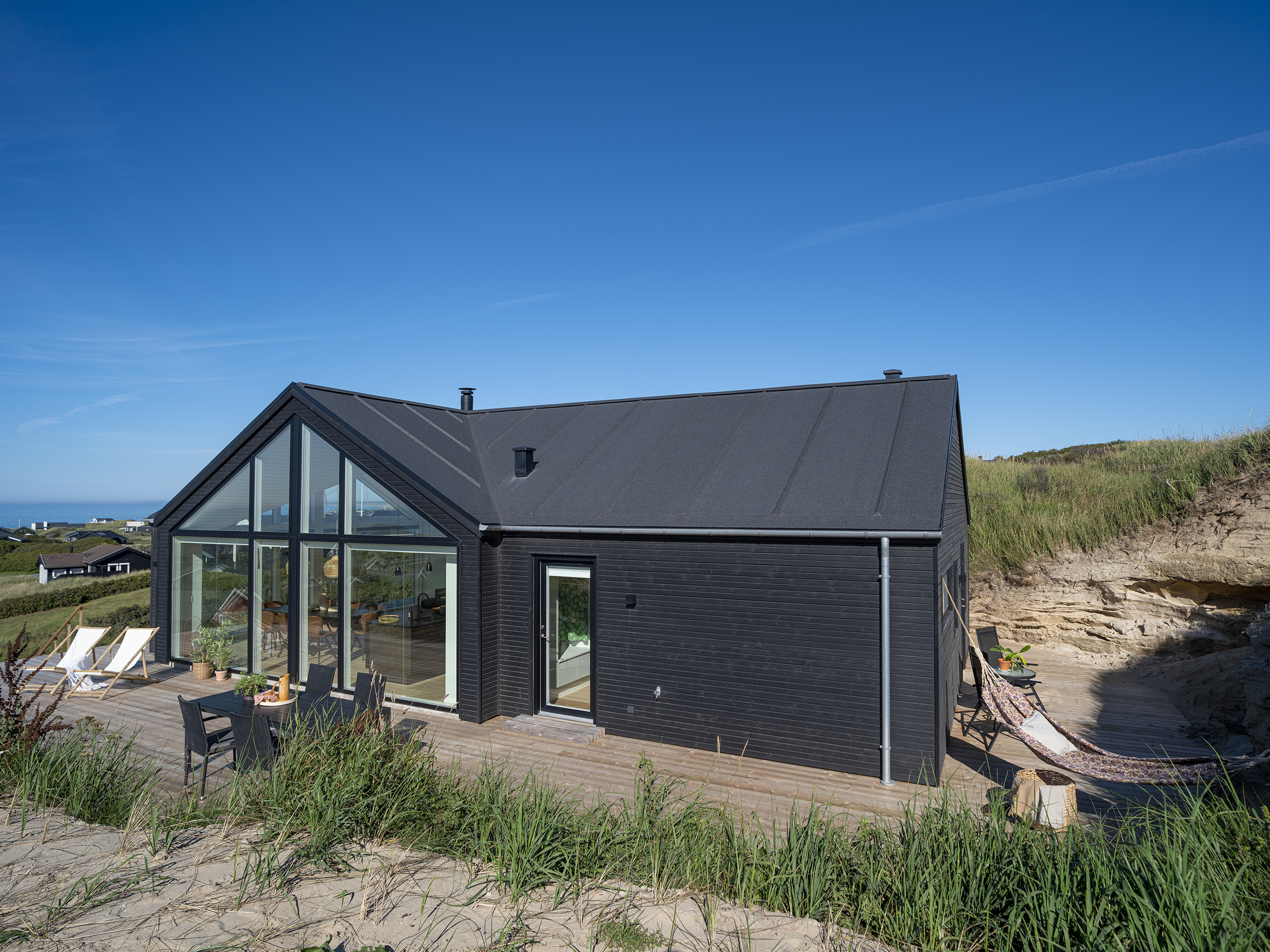 Sommerhus beliggende i område med klitter