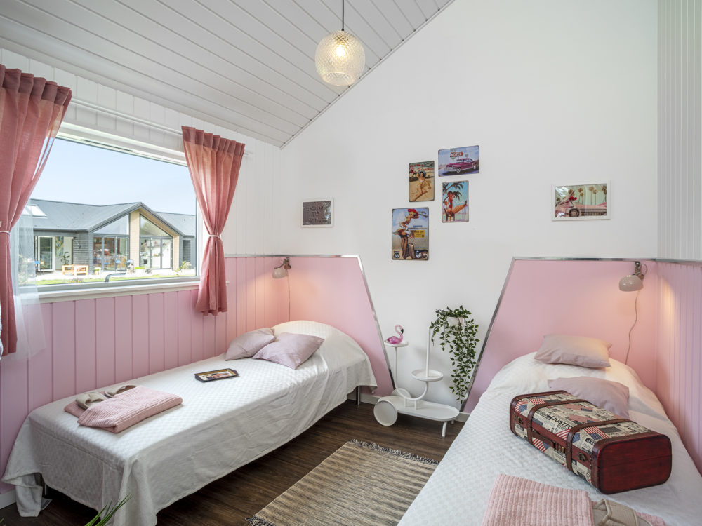 Lyserødt værelse med to enkeltsenge